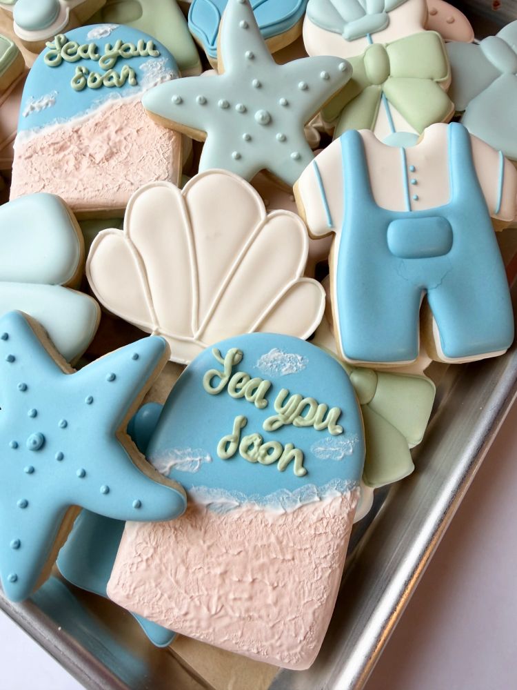 Coastal baby cookies with starfish, shells, and a beach romper