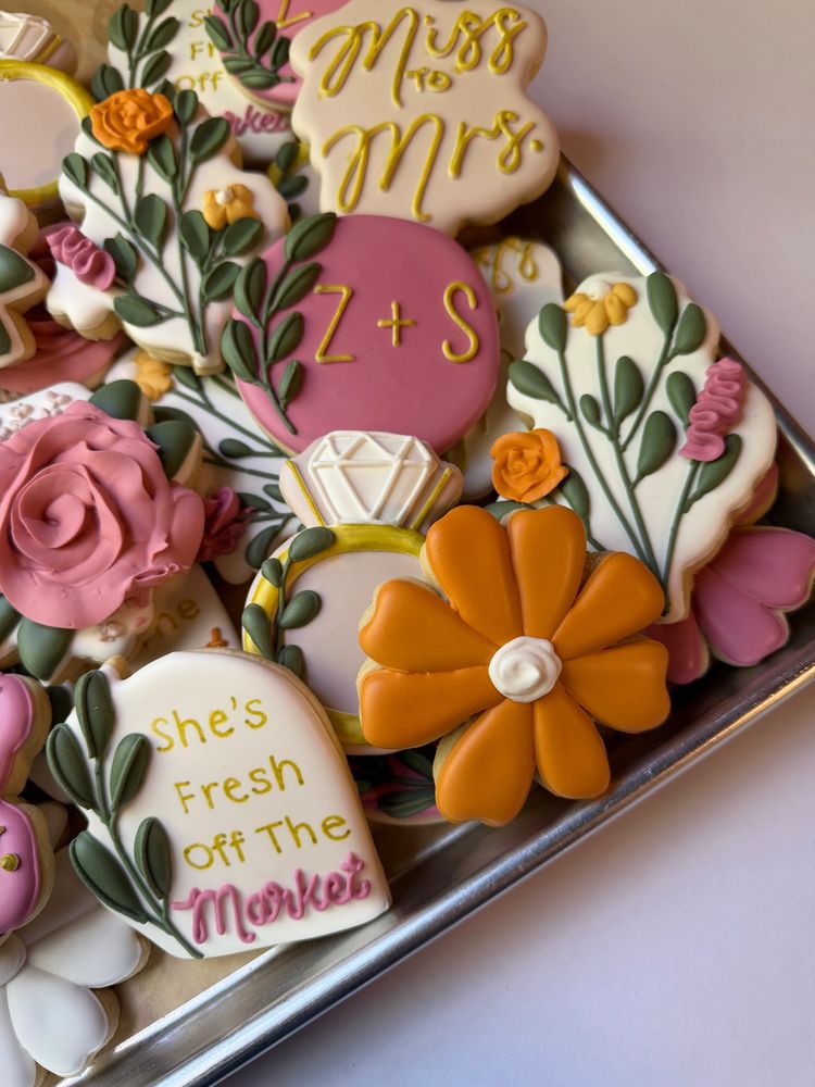 Bridal sugar cookies with a ring, roses, and a miss-to-mrs plaque