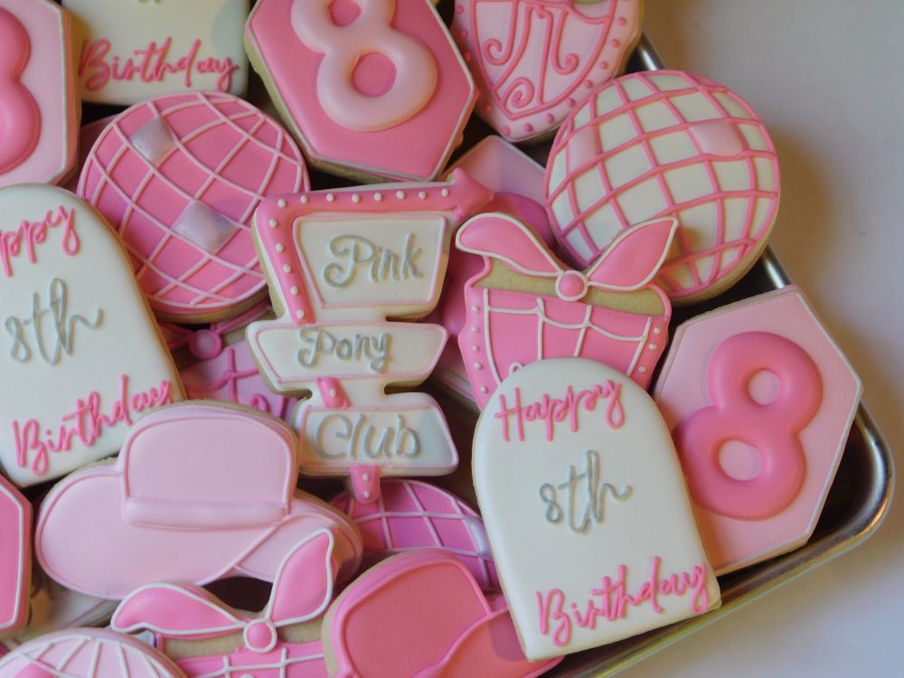 Hot pink eighth-birthday cookies with disco balls, boots, and a pony-club sign