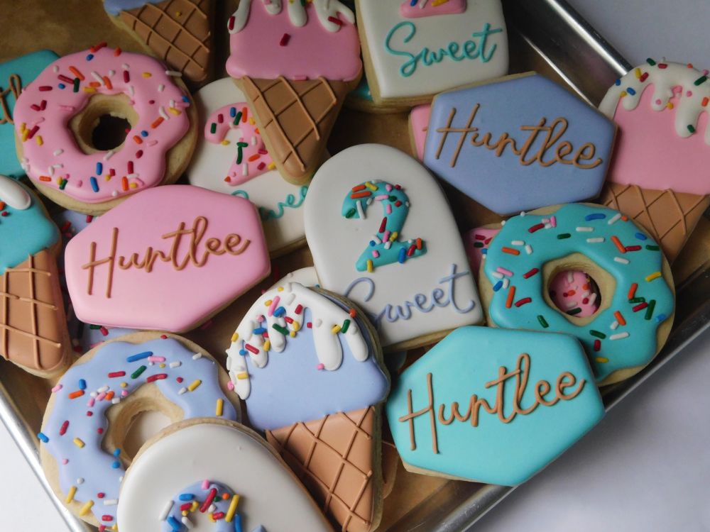 Donut and ice-cream-cone cookies in pink, blue, and sprinkles