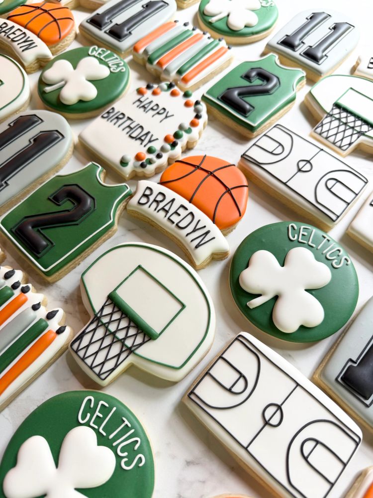 Green basketball cookies with jerseys, a hoop, and shamrocks