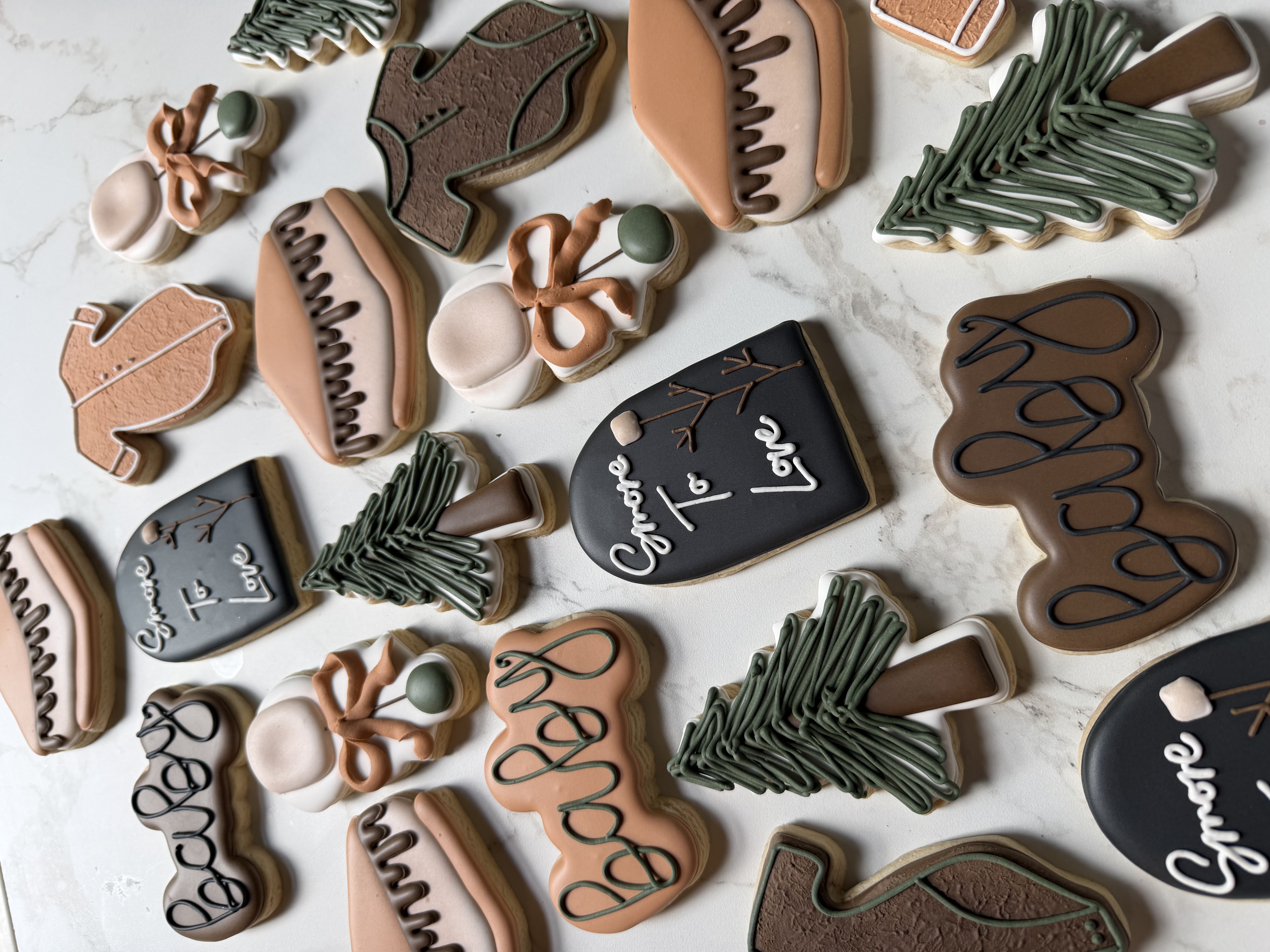 Campfire baby cookies with pines, s'mores, onesies, and S'more to Love plaques